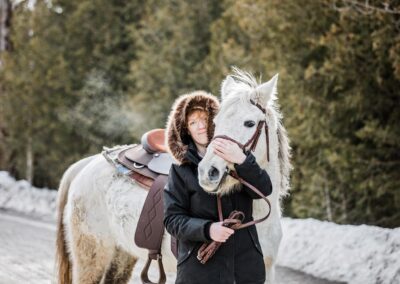 a photo taken in the winter of a young rider and her horse showing the bond they share.